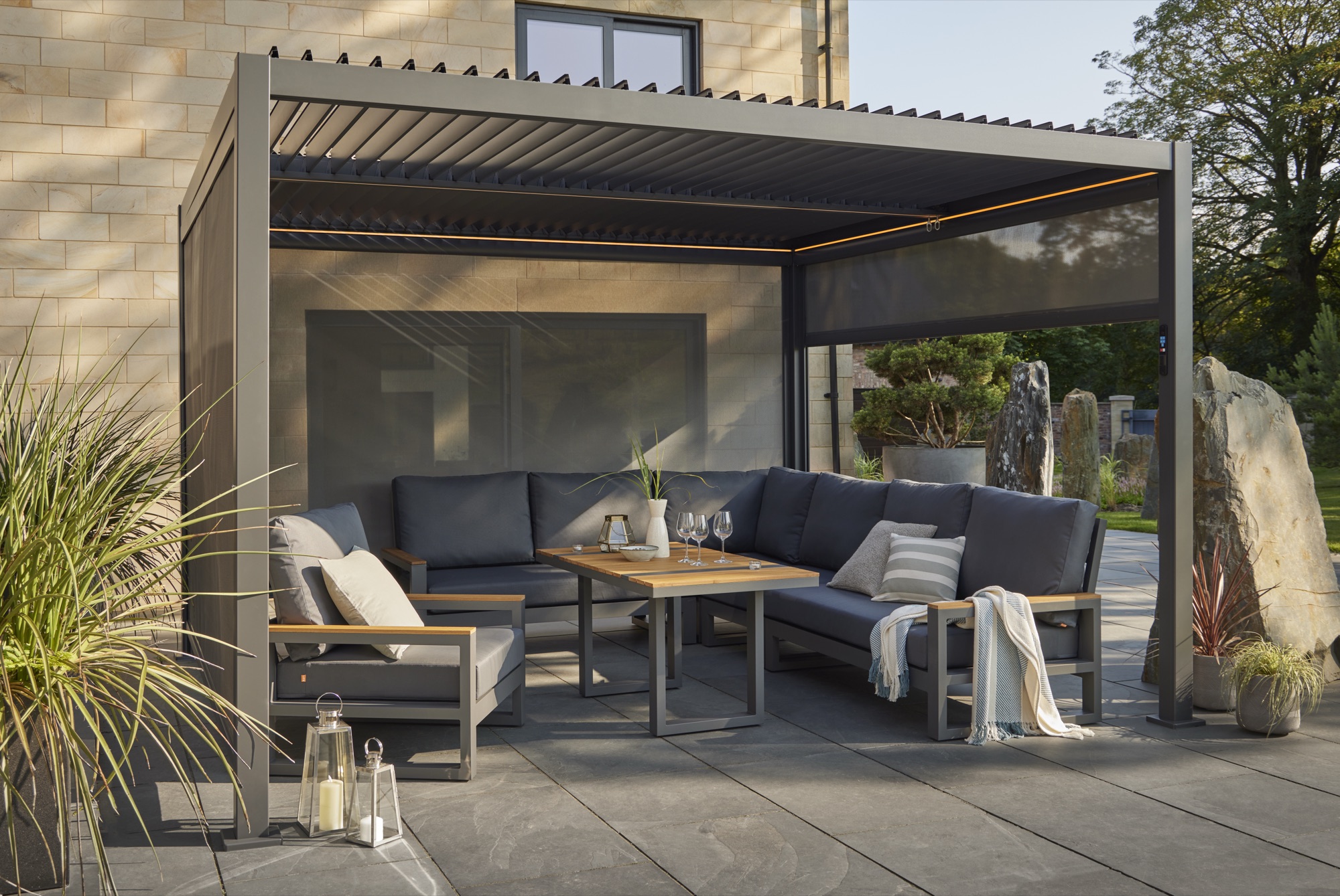 Aluminium pergola in daylight with garden seating