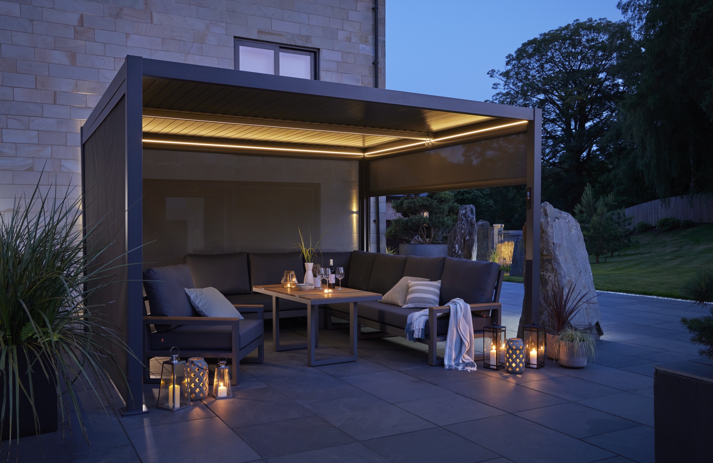 Aluminium pergola at dusk with warm LED lighting