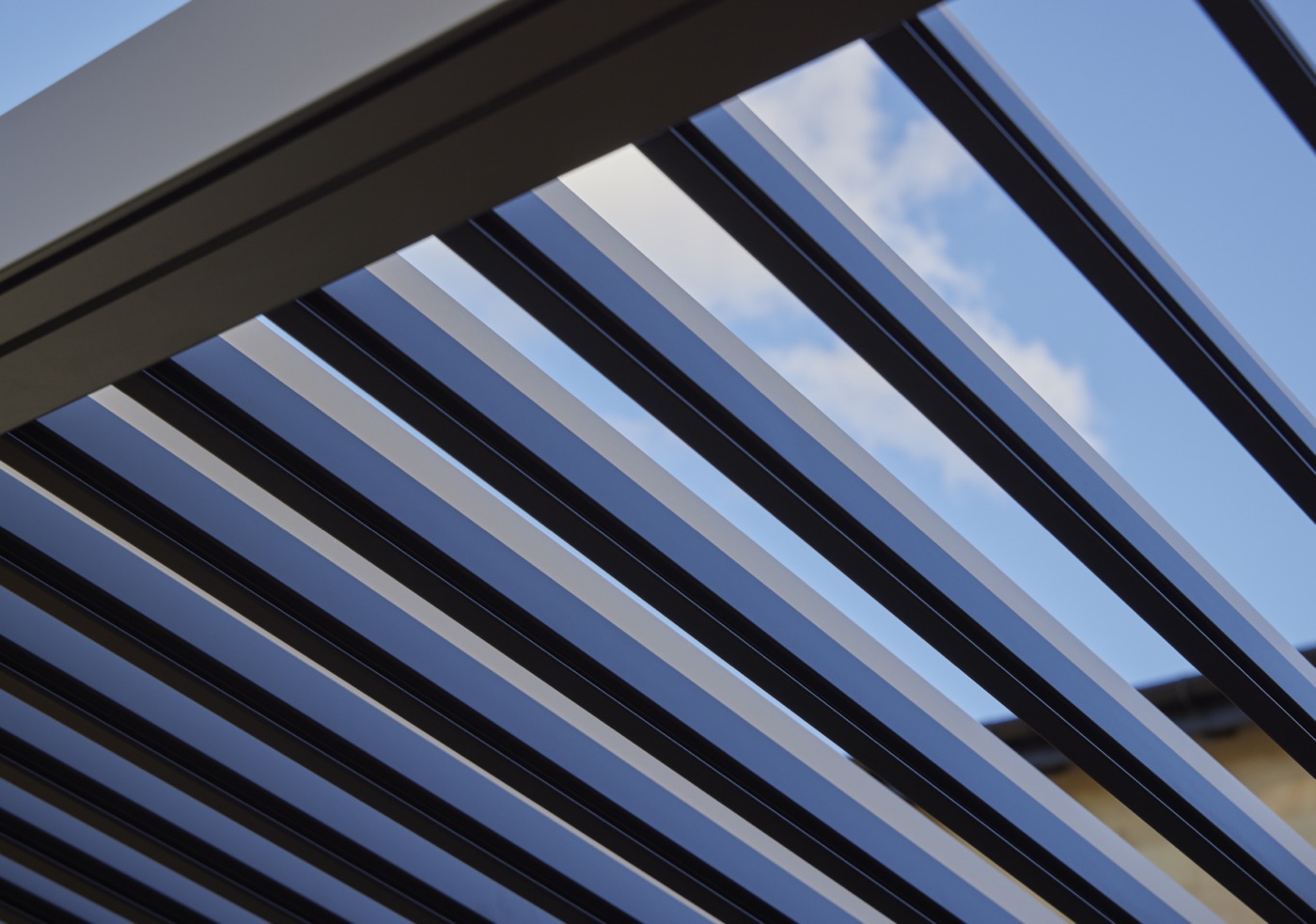 Looking up through aluminium louvres at the sky