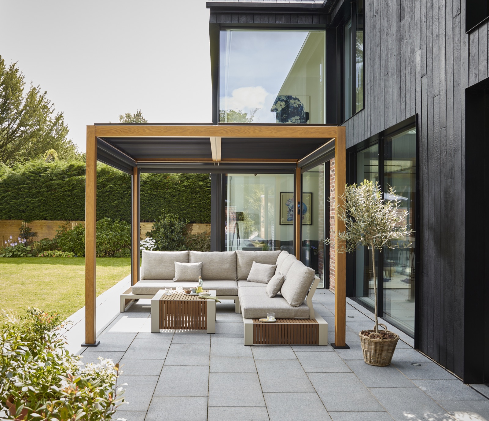 Wood-look pergola fully open in a landscaped garden